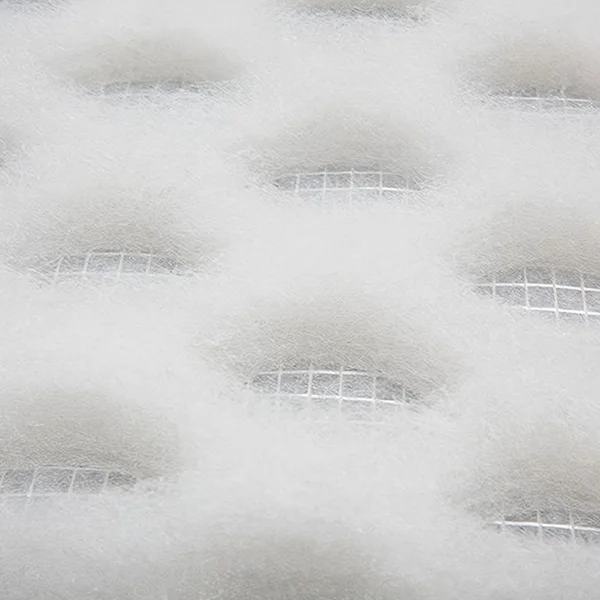 A roll of white coarse air filter material made of DPA synthetic fiber