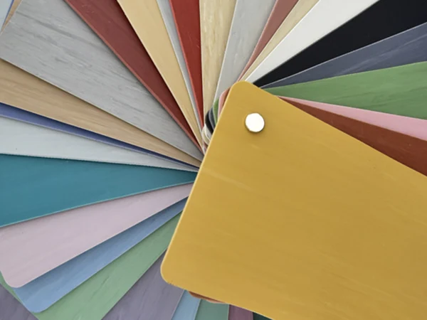 Multiple directional homogeneous PVC flooring samples in various colors stacked together