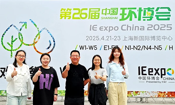 PureFlow employees posing for a group photo in front of the promotional banner