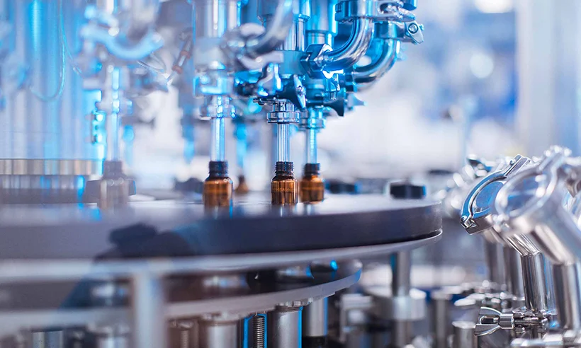 An automated liquid pharmaceutical filling system is in operation.